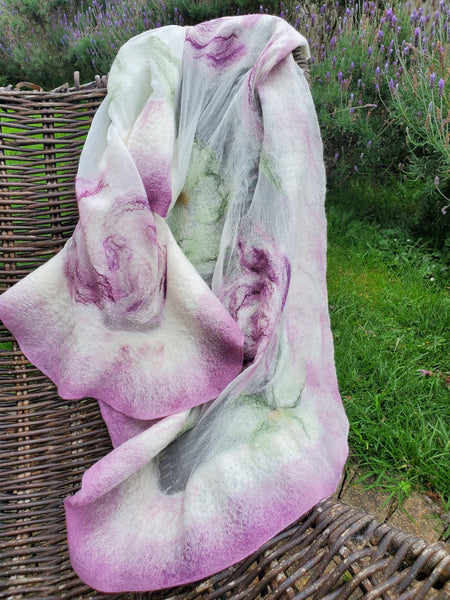 Scarf in soft pastel shades of cream, lavender, and sage green, delicate floral pattern in a romantic, bohemian style.