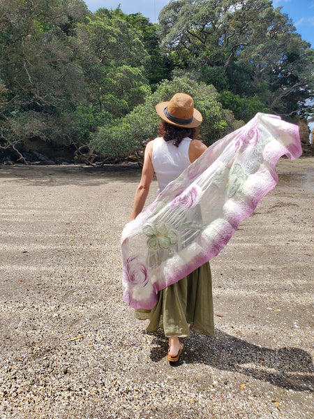 Scarf in soft pastel shades of cream, lavender, and sage green, delicate floral pattern in a romantic, bohemian style.